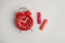 Tampons and red alarm clock on light background, flat lay