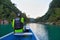 TAMUL, SAN LUIS POTOSI MEXICO - January 6, 2020: Rear view of man in raincoat and vest rowing in canoe. Active, adventure,