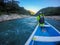 TAMUL, SAN LUIS POTOSI MEXICO - January 6, 2020: Rear view of man in raincoat and vest rowing in canoe. Active, adventure,