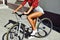 tan sporty young woman on a bicycle