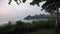 Tanah Lot Temple with green plant on the foreground