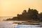 Tanah Lot temple and sea waves in beautiful sunset light