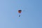 Tandem parachute jump. Silhouette of skydiver flying in blue clear sky