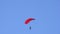 Tandem parachute jump. Silhouette of skydiver flying in blue clear sky