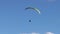 Tandem Paragliding Flight Against Cloudy Sky