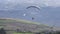 Tandem Paragliding Flying Over Rural Area In Andes