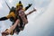 Tandem skydiving. Girl is flying in the cloudy sky.