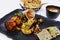 Tandoori platter with chicken tikka, grilled prawns, and paneer along with dal makhani, wheat bread and chutneys, Indian food