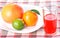 Tangerine, grapefruit, lime, glass of orange juice