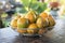 Tangerine in a silver metal basket on the table