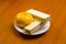 Tangerine and waffles on a white saucer on a wooden background