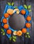 Tangerine wreath whit green leaves on dark wooden with slate and blue towel, food background