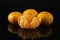 Tangerines on Black Background with Reflection