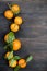 Tangerines clementine with leaves on a wooden table.