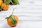 Tangerines clementine with leaves on a wooden table.