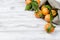 Tangerines clementine with leaves on a wooden table.