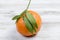 Tangerines clementine with leaves on a wooden table.