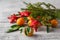 Tangerines, fir tree brunches, pine cones and nuts. Christmas food decorations. Table setting.