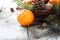 Tangerines, fir tree, pinecones and nuts. Christmas food decorations.