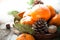 Tangerines, fir tree, pinecones and nuts. Christmas food decorations.