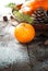 Tangerines, fir tree, pinecones and nuts. Christmas food decorations.