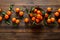 Tangerines fresh mandarin oranges clementines with leaves on wooden background. Top view copy space