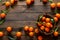 Tangerines fresh mandarin oranges clementines with leaves on wooden background. Top view copy space