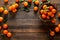 Tangerines fresh mandarin oranges clementines with leaves on wooden background. Top view copy space