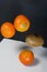 Tangerines and kiwis float above the table surface. Fruit levitation