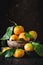 Tangerines with leaves on an old fashioned country table. Selective focus. Vertical.