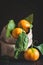 Tangerines with leaves on an old fashioned country table. Selective focus. Vertical.