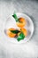 Tangerines with leaves on plate - citrus fruits and healthy eating flatlay concept