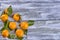 Tangerines with leaves on a wooden background