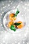 Tangerines, mandarines, clementines in winter holiday time, citrus fruits on plate with glowing snow and glitter on flatlay