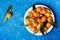 Tangerines or mandarins with green leaves on vintage blue table from above in flat lay style.
