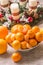 Tangerines and oranges on christmas table with advent wreath