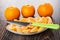 Tangerines, slices of tangerine, knife in plate on wooden table
