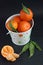 Tangerines in white bucket