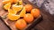 Tangerines whole slices of mint leaves on a cutting Board, an old dark wooden table,close-up with