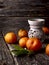 Tangerines on a wooden background. Essential oil burner with citrus fruits