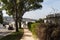 TANGIER, MOROCCO - MAY 27, 2017: Sidewalk near of the one of the automobile road in suburb of Tangier in sunny day