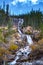 Tangle Creek Falls in Jasper National Park, Alberta, Canada, couple men and woman mid age hiking up to waterfall in