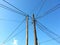 Tangle of electric cables, with blue sky.