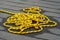 Tangle wet yellow rope on a deck