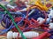 A tangled pile of brightly coloured skipping ropes on the floor