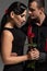 Tango dancer gifting red rose to attractive partner isolated on grey