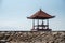 Tanjung Benoa Beach temple and a man sitting and praying