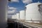 tank farm, with array of tanks and pipes, transporting refined products