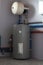 Tank for indirect heating of boiler, expansion tank, boiler piping and meters in boiler room of private house. Vertical