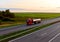 Tank transport of liquid, foodstuff. Metal chrome cistern tanker for food transportation on highway on sunset background